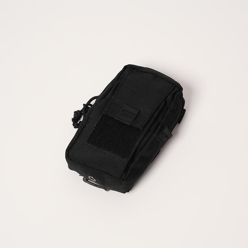 Black travel bag for essentials which attaches onto a baby carrier. 