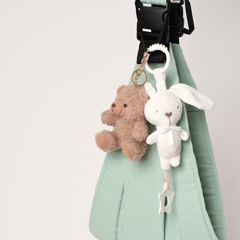 Bear and Bunny stuffed toy pendants attached onto a baby carrier. 
