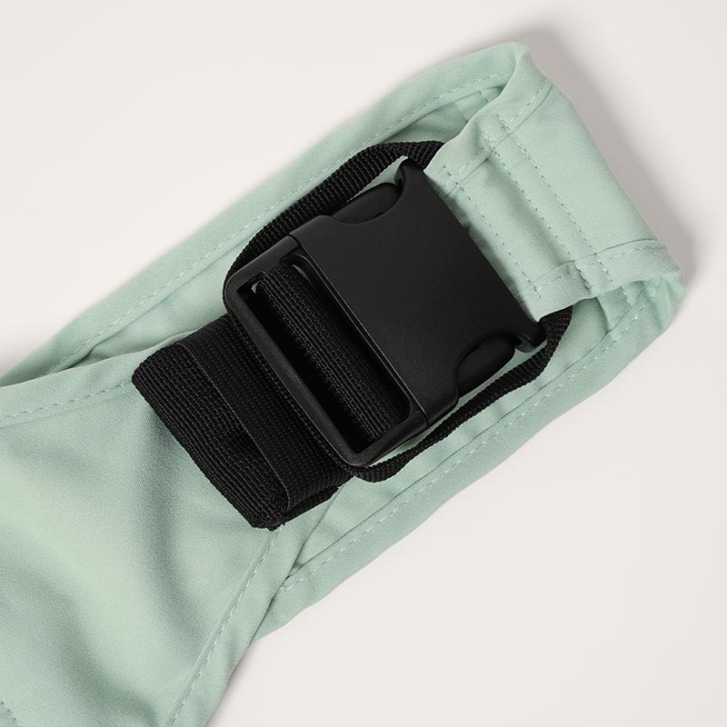 Close up on a buckle on the Nubioo Toddler Carrier. 