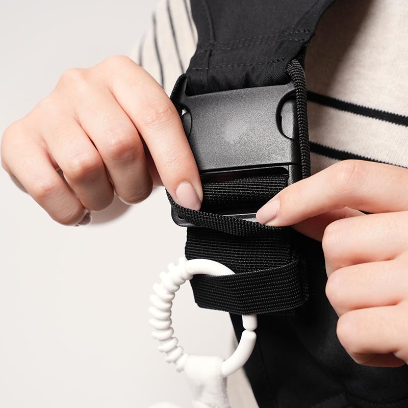 Safety latch that goes over the plastic buckle of the Nubioo Toddler Carrier. 