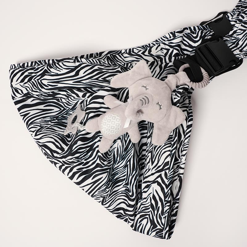 Nubioo Clip-On Soothie for kids attached onto a zebra-print baby carrier.